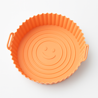 Orange silicone mold for airfryer with smiley face design, non-stick and reusable baking accessory