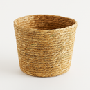 Pot de fleurs en rotin naturel avec un design tissé à la main pour la décoration intérieure et l'aération des plantes.