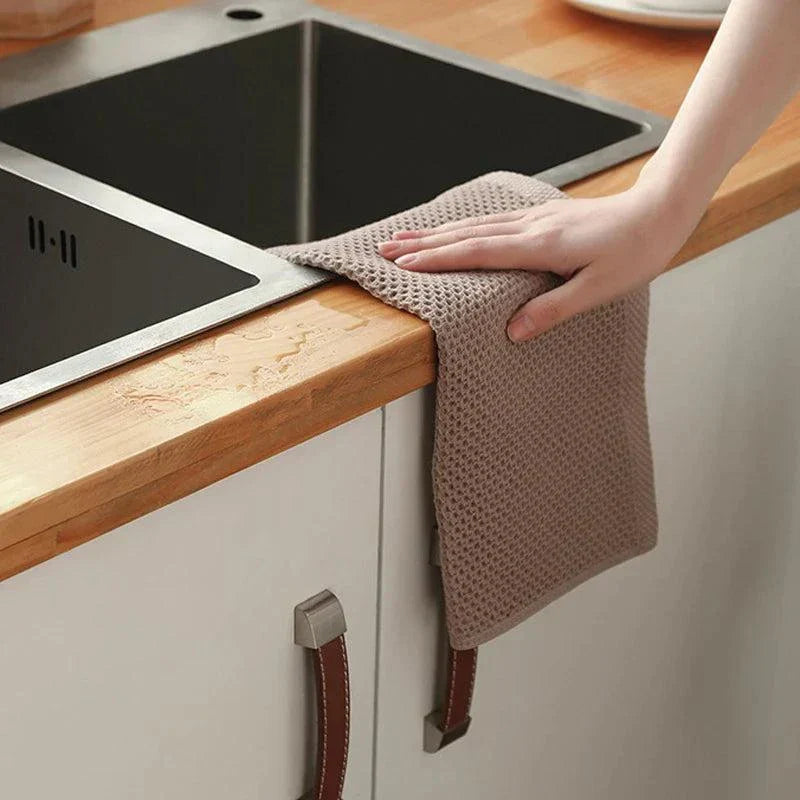 Soft absorbent cotton dishcloth wiping kitchen counter near sink